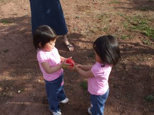 Girls playing the "water balloon toss"